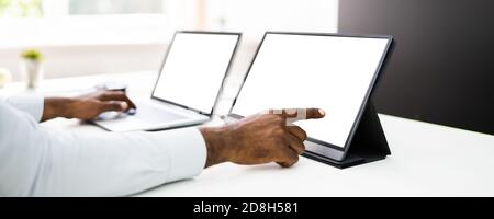 African Manager Working On Corporate Computer With Blank Screen Stock Photo
