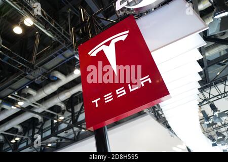 In this unlocated and undated photo, the logo of Tesla, an American electric vehicle and clean energy company, is seen its booth during an exhibition. Stock Photo