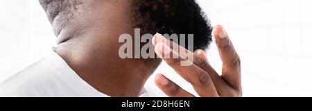 panoramic shot of afro-american man applying cure for strengthening beard growth Stock Photo