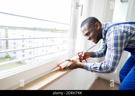 Caulk Sealant Application. Silicone Window Seal And Waterproofing Stock Photo