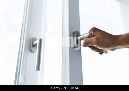 African American Man Opening Office Window Side View Stock Photo