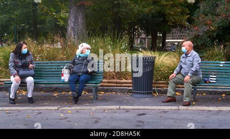 MILAN-ITALY - 11 october 2020: Aged people chatting on a benches near Castello Sforzesco in Milan about corona virus Stock Photo