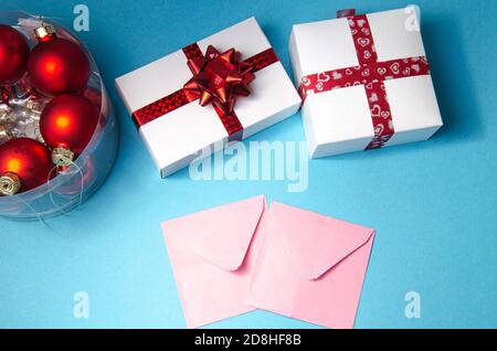 Postcards for the New Year holidays. Two envelopes and two gifts on a blue background Stock Photo