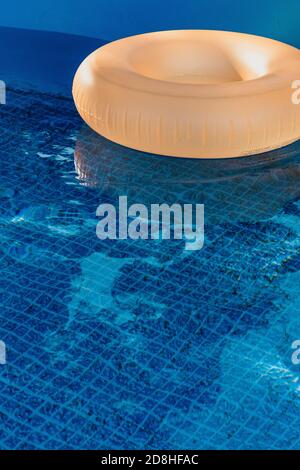 An orange pool ring in a swimming pool Stock Photo - Alamy