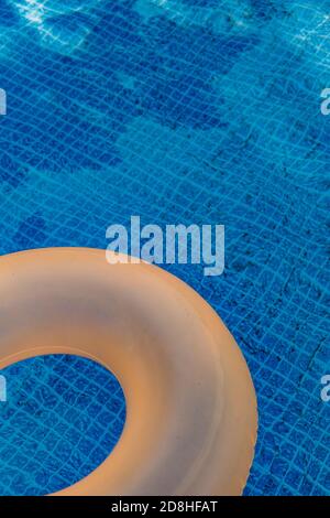 An orange pool ring in a swimming pool Stock Photo - Alamy