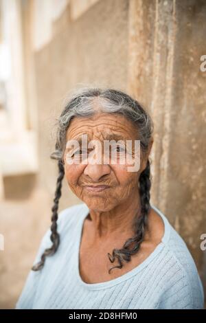 Portrait of a creole female elderly woman with traditional braided hair on the island of Maio, Cape Verde, Africa. Stock Photo