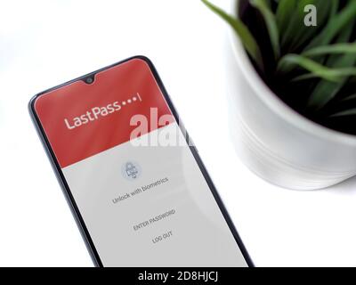 Lod, Israel - July 8, 2020: Modern minimalist office workspace with black mobile smartphone with LastPass Password Manager app launch screen with logo Stock Photo