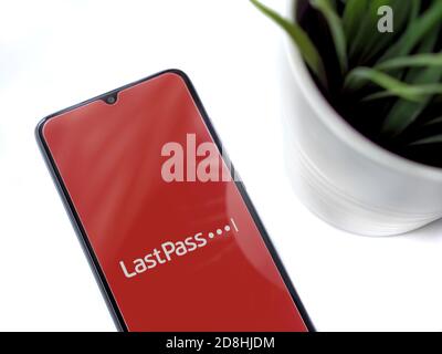 Lod, Israel - July 8, 2020: Modern minimalist office workspace with black mobile smartphone with LastPass Password Manager app launch screen with logo Stock Photo