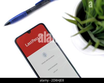 Lod, Israel - July 8, 2020: Modern minimalist office workspace with black mobile smartphone with LastPass Password Manager app launch screen with logo Stock Photo