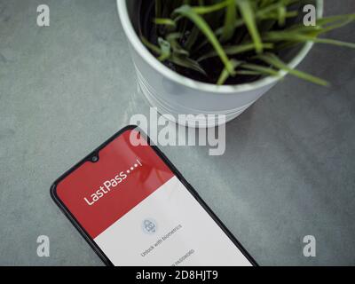 Lod, Israel - July 8, 2020: Modern minimalist office workspace with black mobile smartphone with LastPass Password Manager app launch screen with logo Stock Photo