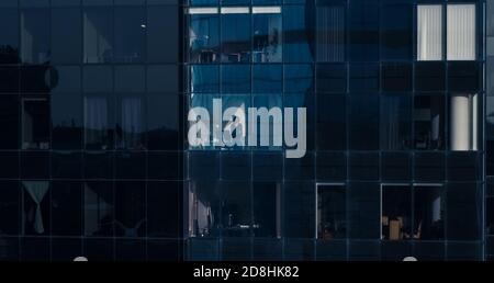 Aerial Shot from the Outside Into Office Building with Businessman Looking out of the Window. Beautiful Shot of The Financial District Skyscrapers. Stock Photo
