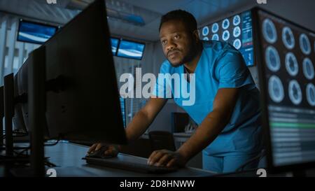 Medical Scientists Neurologists, Working on a Personal Computer in Modern Laboratory. Research Scientists Making New Discoveries in the fields of Stock Photo