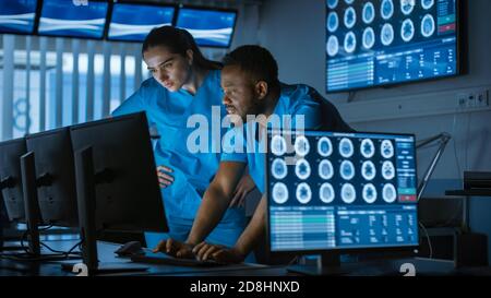 Male and Female Scientists Neurologists, Talking and Working on a Personal Computer in Modern Laboratory. Research Medical Scientists Making New Stock Photo