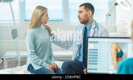 Friendly Doctor Consoles Female Patient, Lightly Touching Her Shoulder in Consolation. Kind Gestures from Professional. Nurse Working on Personal Stock Photo