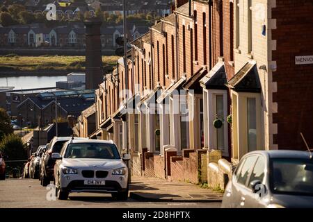 UK, Wales, Glamorgan, Barry, Town Centre, Trinity Street, Gavin and Stacey filming location, terraced houses on steep hill Stock Photo