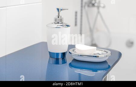 Liquid and ordinary soap in the bathroom. Cleanliness of hands and body. Stock Photo