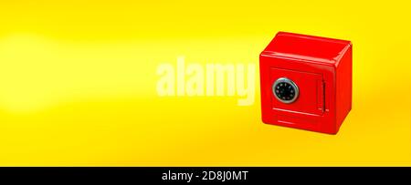 Red moneybox (piggy bank) made as safe. on yellow background  with copy space Stock Photo