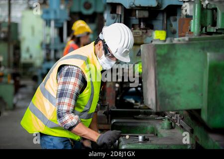 Engineers operating a cnc machine in factory Stock Photo