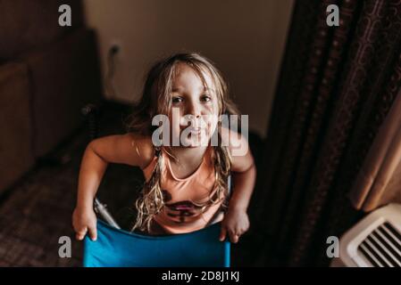 Close up funny portrait of preschool aged adorable girl in hotel room Stock Photo