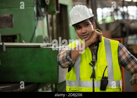 Engineers operating a cnc machine in factory Stock Photo