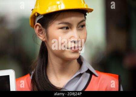 Engineers operating a cnc machine in factory Stock Photo