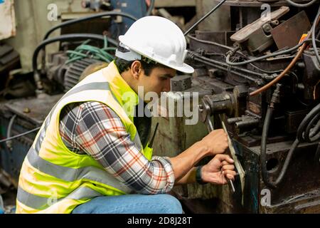 Engineers operating a cnc machine in factory Stock Photo
