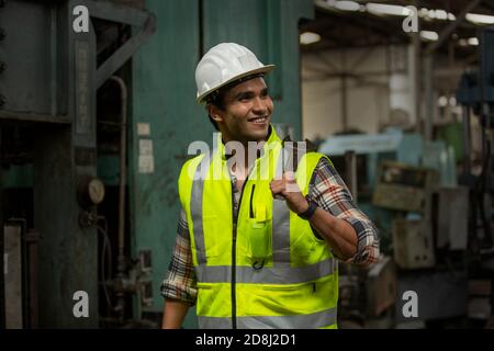 Engineers operating a cnc machine in factory Stock Photo