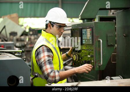 Engineers operating a cnc machine in factory Stock Photo