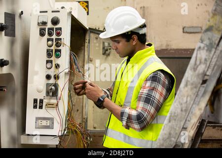 Engineers operating a cnc machine in factory Stock Photo