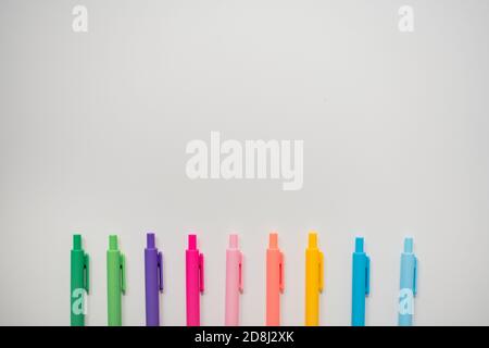 brightly colored markers lined on white background Stock Photo