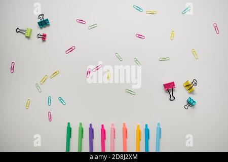 colorful markers and paper clips on white background Stock Photo