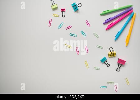 rainbow school supplies on plain white background Stock Photo