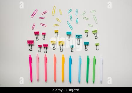 colorful school supplies on plain white table Stock Photo