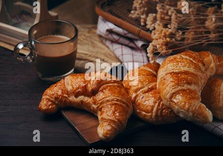 Croissants and a cup of coffee on the table Stock Photo