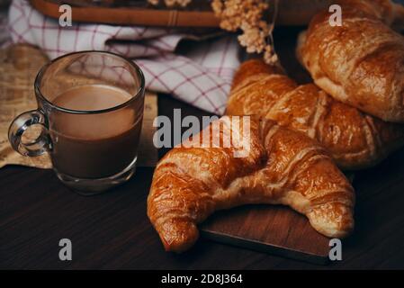 Croissants and a cup of coffee on the table Stock Photo