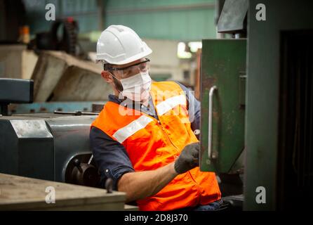 Engineers operating a cnc machine in factory Stock Photo