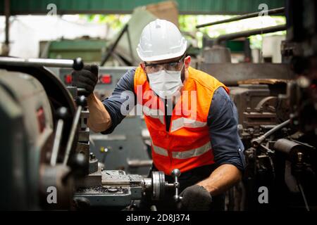 Engineers operating a cnc machine in factory Stock Photo