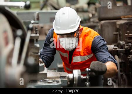 Engineers operating a cnc machine in factory Stock Photo