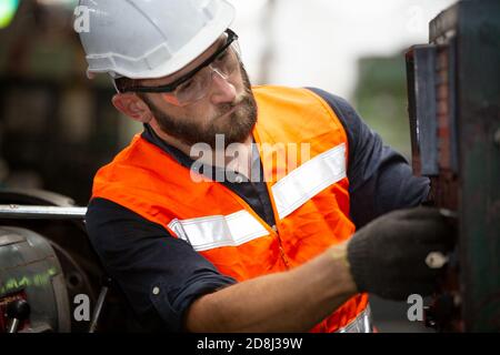 Engineers operating a cnc machine in factory Stock Photo