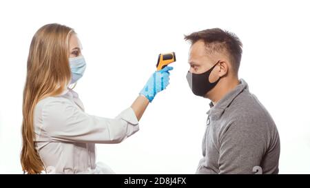 Medical worker measures temperature by thermometer Stock Photo