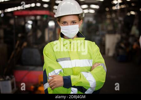 Female with mask Engineers standing in factory Stock Photo