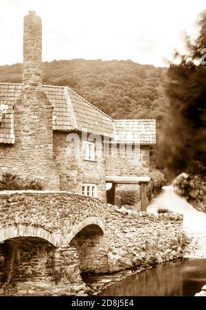 Sepia toned photograph taken on a paper negative in a 7 x 5 inch plate camera in July 2020 of the house beside the medieval packhorse bridge on Exmoor Stock Photo