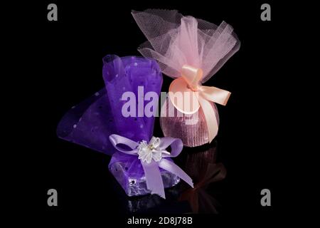 Two chocolate candies isolated on black background, sweet gift Stock Photo