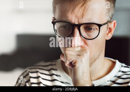 Thoughtful male entrepreneur wear glasses thinking, solving problem. Pensive upset exhausted guy feeling frustrated depressed tired. Mental health, af Stock Photo