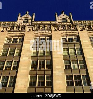 Low Angle View of Exterior of Stone Apartment Building Stock Photo