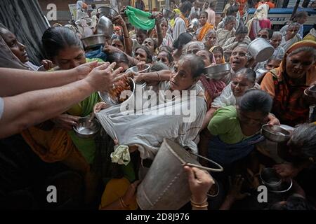 Vrindavan, India, August 2009. Widows fighting over food. Stock Photo