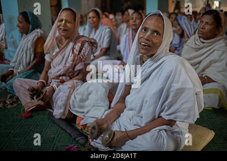 Vrindavan, India, August 2009. Widows gathered to pray inside an ashram. Stock Photo