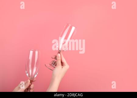 Wine glasses on a pink background in the hands of a woman. Stock Photo