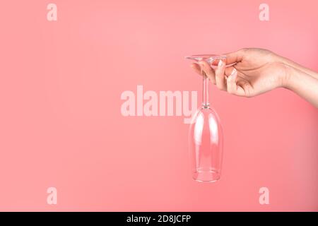 Abstract background with a woman's hand holding a champagne glass upside down. Stock Photo