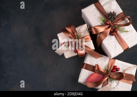 Three beautifully decorated gift boxes on a brown background. Stock Photo